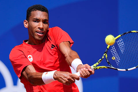 Felix Auger-Aliassime returns a backhand shot to Carlos Alcaraz